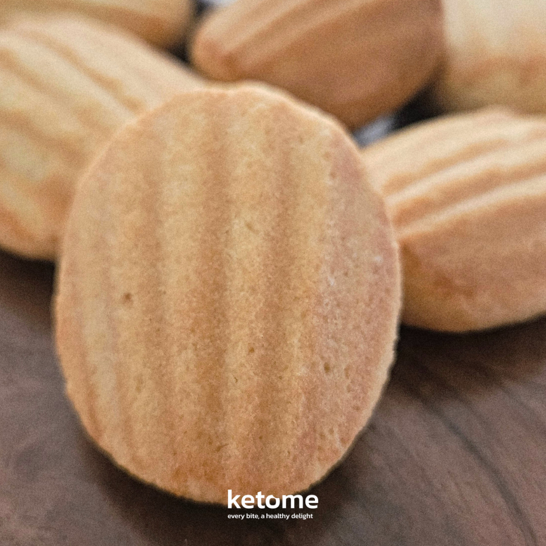 Close-up of almond cookies with 'ketome' branding on a wooden surface