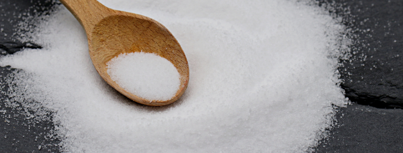 A close-up of a person holding an apple and a donut, symbolizing the choice between healthy eating and indulgence.