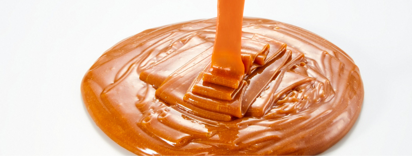 Smooth and creamy peanut butter texture with swirls, perfect for food and culinary themes.