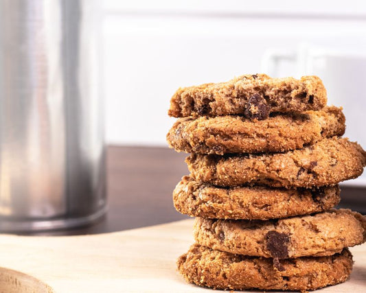 A delicious stack of homemade chocolate chip cookies with a bite taken, perfect for dessert imagery.