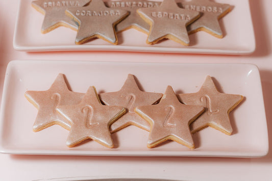 Festive star-shaped cookies on pink plates, perfect for a children's birthday celebration.