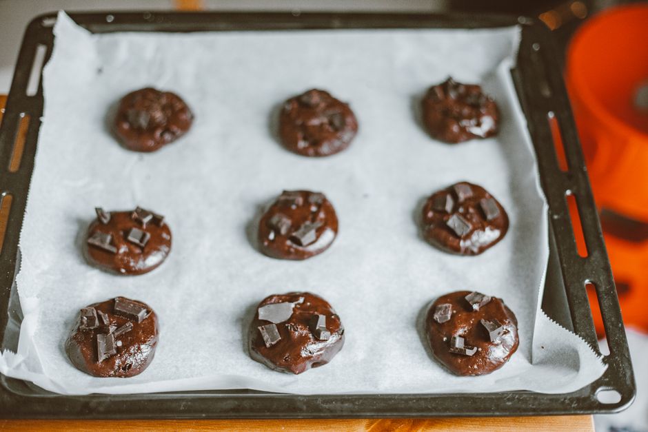 Delicious homemade chocolate chunk cookies on a parchment-lined baking tray, ready for baking.