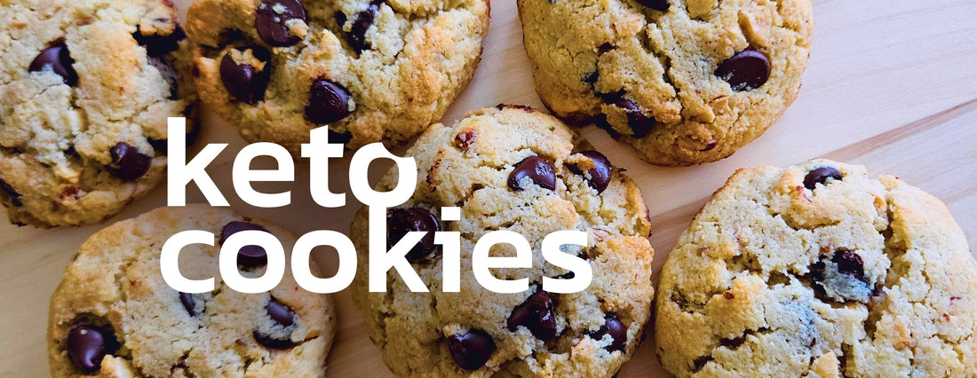 A delicious stack of chocolate chip cookies on a wooden surface with cookie crumbs around.